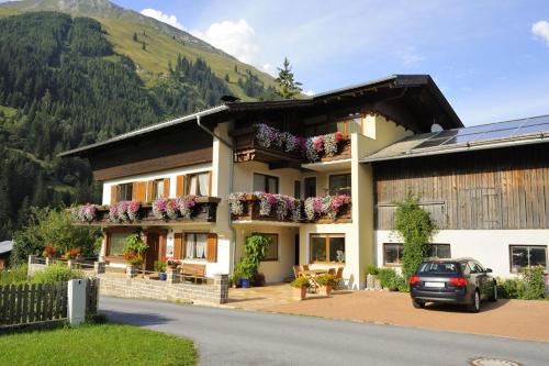 a house with flower boxes on the side of it at Haus Alpina in Häselgehr