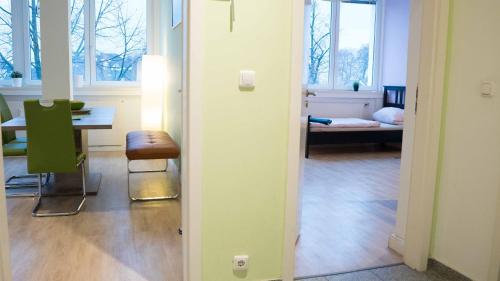 a room with a table and a chair and a room with a bedroom at Work & stay Langenfeld in Langenfeld
