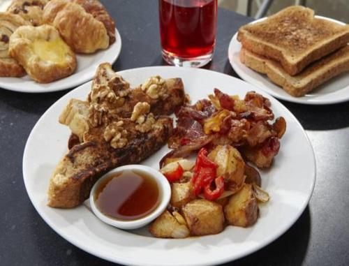 three plates of food on a table with breakfast foods at Divi Aruba Phoenix Beach Resort in Palm-Eagle Beach