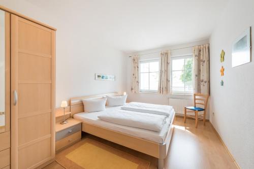 a small bedroom with a bed and a window at Haus Kastanienblick by Rujana in Binz