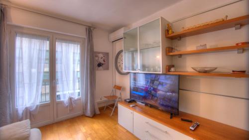 a living room with a flat screen tv on a dresser at 2 Pièces 57 Rue d'Antibes proche Palais in Cannes