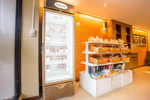 a refrigerator with food inside of it in a store at Novotel Rayong Rim Pae Resort in Klaeng