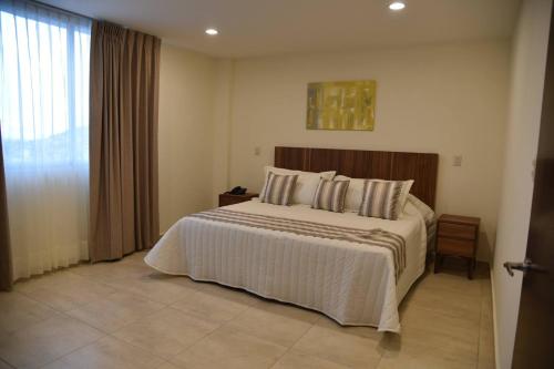 Ένα ή περισσότερα κρεβάτια σε δωμάτιο στο Suites San Pedro