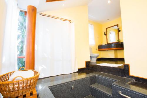 a bathroom with a large sink and a toilet at Novotel Rayong Rim Pae Resort in Klaeng