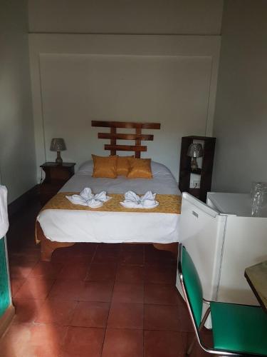a bedroom with a bed with towels on it at Hotel Don Robert in Puntarenas