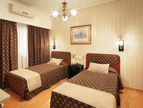 Säng eller sängar i ett rum på Gran Hotel De La Paix