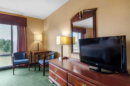 a hotel room with a large flat screen tv at Quality Inn & Suites in Carthage