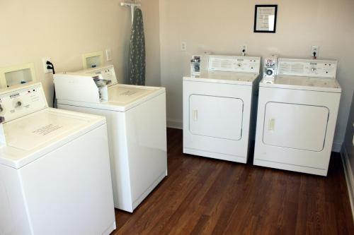 a laundry room with two washers and two dryers at Affordable Suites Conover / Hickory in Conover