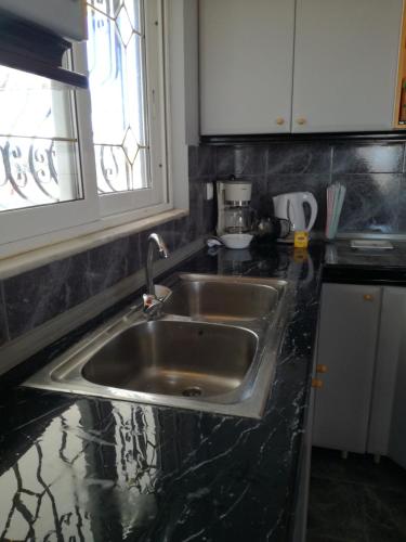 a kitchen with a sink and a counter top at Seven Seas Apartments in Artemida