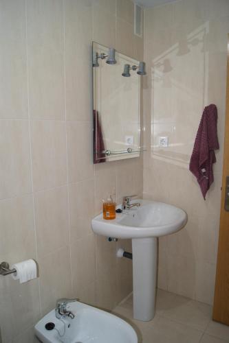 a bathroom with a sink and a toilet at Apartamento Unquera - Cantabria in Unquera