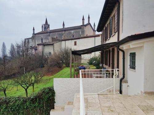 a building with a gate and a castle in the background at Foresteria Borgo Delle Grazie in Curtatone