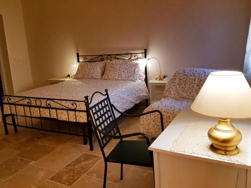 a bedroom with two beds and a table with a lamp at Foresteria Borgo Delle Grazie in Curtatone