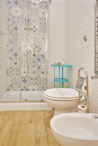 a bathroom with a shower and a toilet and a sink at Napoli Tree - Lungomare in Naples