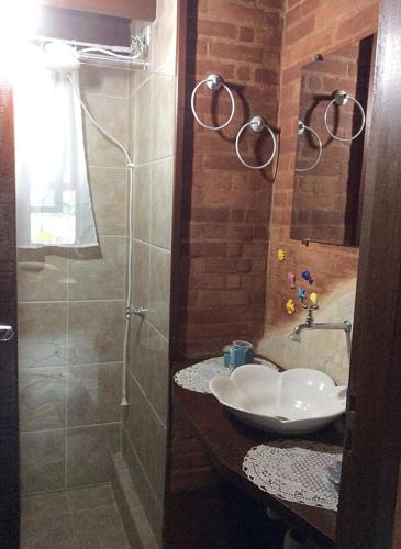 a bathroom with a sink and a shower at Recanto Marazul in Ubatuba