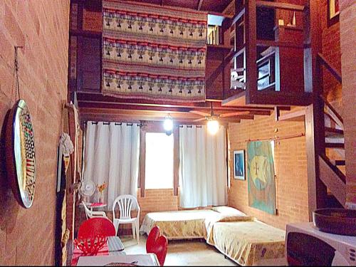 a bedroom with two beds and a window at Recanto Marazul in Ubatuba