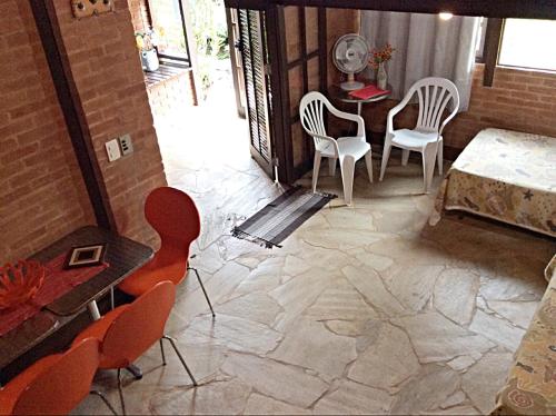 a view of a room with chairs and a table at Recanto Marazul in Ubatuba