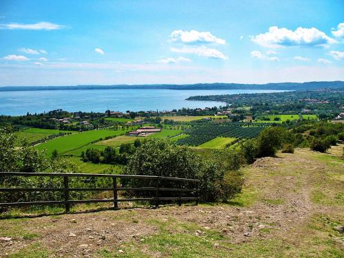 a view of the ocean from a hill with a fence at Residence Bellavista in Manerba del Garda