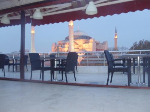a patio with a table and chairs in front of a building at Ares Hotel in Istanbul