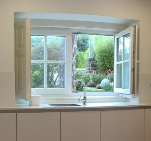 a kitchen with a sink and a window at DOMUS QUIETA Pool near beach in Colares