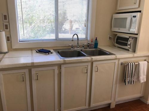 a kitchen with a sink and a microwave at Shoshone RV Park in Shoshone