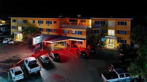 a building with cars parked in a parking lot at Page Terrace Beachfront Hotel in St Pete Beach