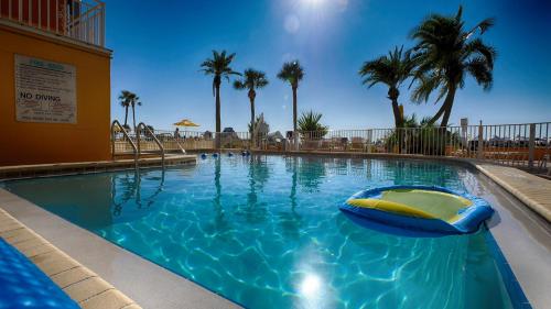 a swimming pool with a raft in the middle at Page Terrace Beachfront Hotel in St Pete Beach