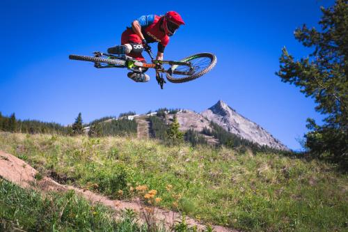 a man doing a trick on a bike in the air at The Grand Lodge Hotel and Suites in Mount Crested Butte