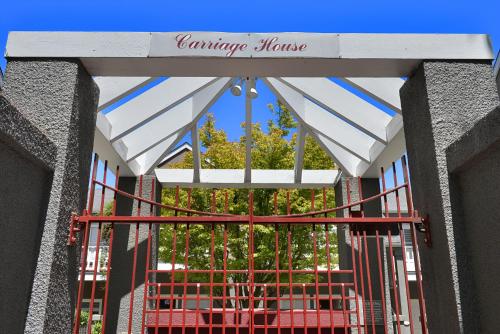a gate with a sign that reads campus house at Hotel La Rose in Santa Rosa