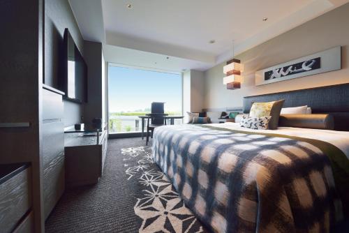 a hotel room with a bed and a large window at Hotel New Otani Tokyo The Main in Tokyo