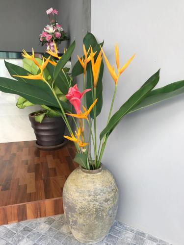 a vase with flowers in it sitting on a floor at Aonang Sea Valley Resort in Ao Nang Beach