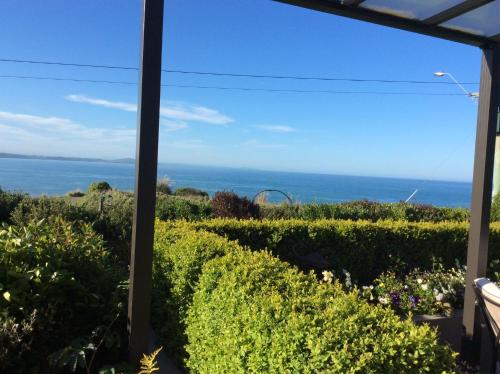 a view of the ocean from a house at Noah's Boutique Accommodation Moeraki in Moeraki