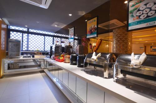 a fast food restaurant with a long counter with food at Jinjiang Inn Suzhou Railway Station North Square in Suzhou