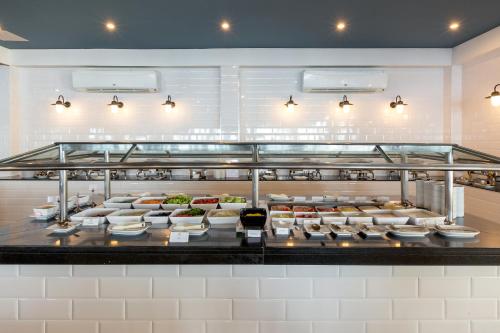 a buffet line with plates of food in a restaurant at Sunwing Bangtao Beach in Bang Tao Beach