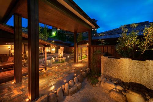 a patio of a house at night with lights at Kurotake in Achi