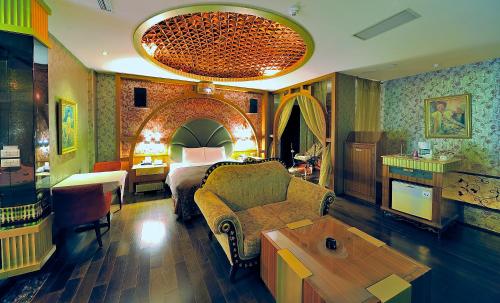 a bedroom with a bed and a living room at Hakodate Motel in Kaohsiung