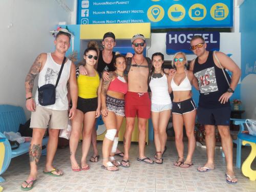 a group of people posing for a picture at a beach at HuaHin Night Market Hostel in Hua Hin