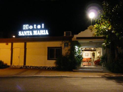 a building with a sign that reads sasyma maria at night at Hotel Santa María in Palos de la Frontera