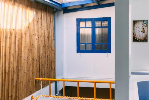 a room with a window and a wooden wall at Aekkeko hostel in Phuket Town