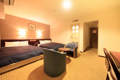 Ένα ή περισσότερα κρεβάτια σε δωμάτιο στο Quintessa Hotel Ogaki