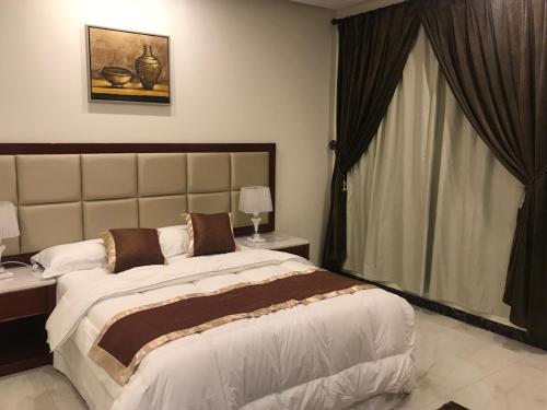 Katil atau katil-katil dalam bilik di Ashbilia Suites