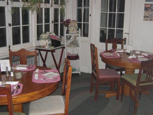 a dining room with a wooden table and chairs at Brookview Manor Inn in Canadensis