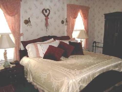 a bedroom with a bed with pillows on it at Brookview Manor Inn in Canadensis