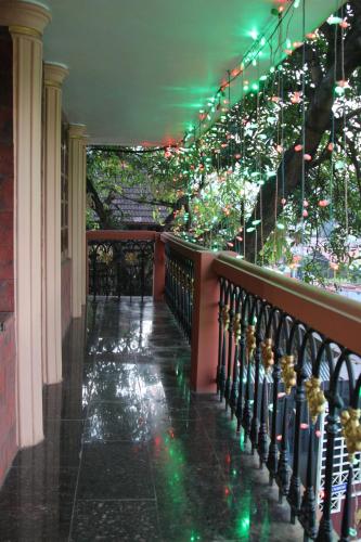 a hallway with a staircase with christmas lights at ShivalayaHomestay in Trichūr