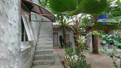 a set of stairs leading up to a building at Baantantara in Suan Phung