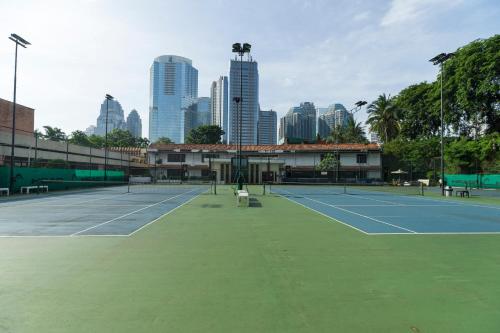 
a man standing on a tennis court holding a racquet at The Sultan Hotel & Residence Jakarta in Jakarta
