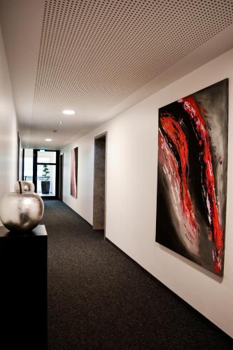 a hallway with a large painting on the wall at Campushotel in Hagen