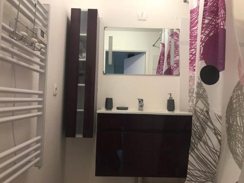 une salle de bain avec un lavabo et un miroir dans l'établissement Domaine de Bussy, à Bussy-Saint-Georges