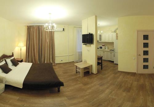 a bedroom with a bed and a living room at Studio on Sobornaya in Mykolaiv