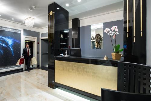 a dressing room with a counter and a woman in a store at Art Hotel Orologio in Bologna