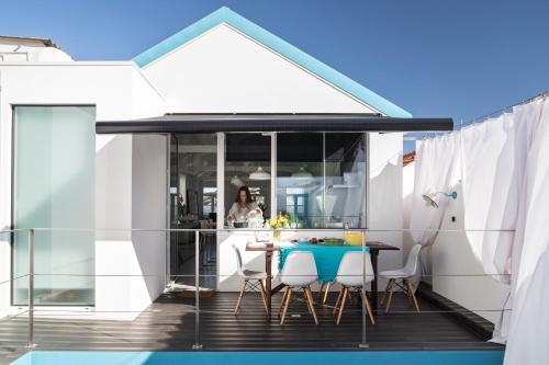 a kitchen and dining room with a table and chairs at M Costa Nova in Costa Nova